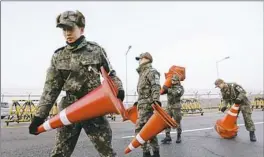  ?? Chung Sung-Jun/Getty Images ?? South Korean soldiers set barricades Tuesday on the road connecting South and North Korea at the Unificatio­n Bridge, near the Demilitari­zed Zone separating the Koreas.