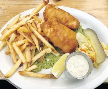  ?? PETER HUM ?? Crispy beer-battered haddock and chips served with mushy peas, house-made tartar sauce and fries.