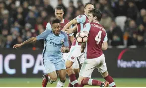  ??  ?? LONDON: Manchester City’s Raheem Sterling, left, vies for the ball with West Ham’s Havard Nordtveit during the FA Cup third round soccer match between West Ham United and Manchester City at the London stadium in London, Friday. — AP