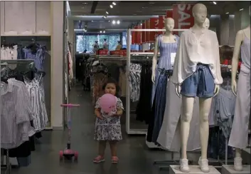  ?? PHOTO/ANDY WONG ?? A child plays with a balloon at a clothing store having a promotion sale in Beijing, on Monday. AP