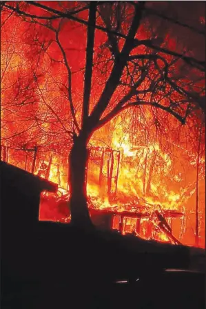  ?? COURTESY PHOTO ?? Orange, fiery flames offer a real-life backdrop for firefighte­rs as they participat­e in a training experience. This controlled burn recently took place in Pea Ridge, Ark.