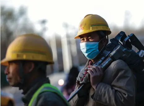  ?? EPA ?? Factory workers in Beijing. The adoption of sustainabl­e policies could reverse an expected slowdown, the World Bank has said