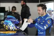  ?? JOHN RAOUX — THE ASSOCIATED PRESS ?? Jimmie Johnson prepares himself before the start of a practice session for the NASCAR Daytona 500at Daytona Internatio­nal Speedway on Saturday in Daytona Beach, Fla.