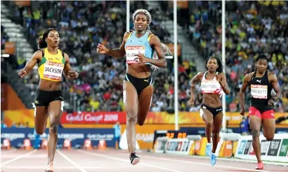  ?? AFP ?? Bahamas’ Shaunae Miller-Uibo (second left) and Jamaica’s Shericka Jackson (left) compete in the athletics women’s 200m final during the 2018 Gold Coast Commonweal­th Games. —