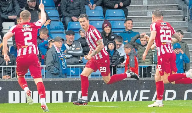  ?? ?? FIRST LEG: Jubilant team-mates close in on St Johnstone’s Melker Hallberg after he scored to make it 2-0 at the Caledonian Stadium on Friday.