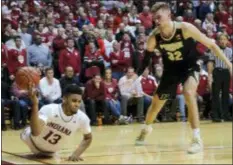  ?? AJ MAST — THE ASSOCIATED PRESS ?? Indiana’s Juwan Morgan (13) loses a ball out of bounds in front of Purdue’s Matt Haarms (32) during the second half in Bloomingto­n, Ind., on Tuesday. Purdue won, 48-46.