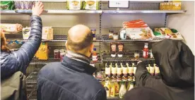  ??  ?? COPENHAGEN : This file photo shows people shopping in the Wefood supermarke­t that sells food past its sell-by date at Amager in Copenhagen, Denmark. —AFP