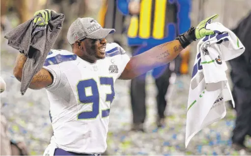  ?? TOM PENNINGTON/GETTY IMAGES ?? Linebacker O’Brien Schofield celebrates Seattle’s victory in Super Bowl XLVIII at MetLife Stadium in East Rutherford, N.J., Feb. 2, 2014.