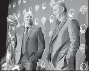  ?? LM Otero Associated Press ?? COACHES Clay Helton, left, and Urban Meyer eye the trophy that goes to the Cotton Bowl winner.