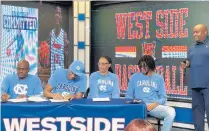  ?? MICHAEL OSIPOFF/POST-TRIBUNE ?? West Side senior Jalen Washington, second from left, signs his national letter of intent to play basketball for North Carolina while surrounded by his father Jimmie Washington Sr., from left, his mother Jada Sterling, brother Jimmie Washington Jr., and West Side coach Chris Buggs on Wednesday.