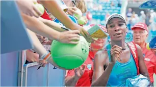  ?? AFP ?? Venus Williams signs autographs after defeating Alison Riske. —