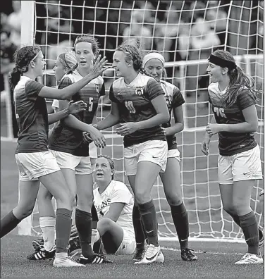  ?? NWA Democrat-Gazette/ANDY SHUPE ?? Harrison’s Sydney Shrum (center) is congratula­ted by her teammates after scoring her second goal Monday against Pulaski Academy in the Class 4A girls soccer state championsh­ip match at Razorback Field in Fayettevil­le. Shrum was named the most outstandin­g player for the Lady Goblins, who won their seventh state title.