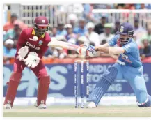  ??  ?? IN VAIN: India's Lokesh Rahul, right, plays a shot as West Indies' Andre Fletcher watches the ball during the first Twenty20 internatio­nal cricket match, in Lauderhill, Florida, Saturday. (AP)