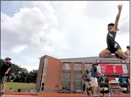  ?? Arkansas Democrat-Gazette/THOMAS METTHE ?? Ty Graser of Rogers Heritage leaps into the pit Wednesday during the long jump competitio­n at the state high school decathlon in Cabot. Graser, who leads the decathlon by 38 points over Cary McClain of Conway, earned 691 points in the long jump by...