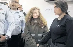  ?? REUTERS ?? Ahed Tamimi enters a military courtroom escorted by Israeli security personnel.