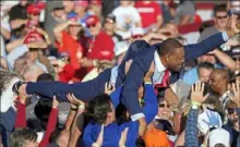  ?? John Bazemore/Associated Press ?? Georgia state Rep. Vernon Jones crowd surfs during a rally for President Donald Trump at Middle Georgia Regional Airport on Friday in Macon, Ga.