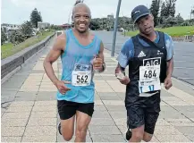  ?? SUPPLIED Picture: ?? ALL SMILES: Mgo Mgoduka of Qokolweni AC and Zolile Tikini (no club in a temp licence number) in good spirit with 3km to go of the Masters Marathon on Sunday.