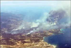  ?? AP/NADINE ACHOUI-LESAGE ?? Wildfires burn Wednesday on the outskirts of the town of Bormes-les-Mimosas on the French Riviera.