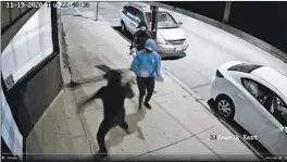  ?? SURVEILLAN­CE VIDEO ?? A still photo from a surveillan­ce video shows three people throwing bricks at the office of 15thWard Ald. Raymond Lopez on Thursday night.