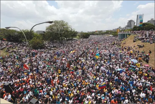  ?? The Associated Press ?? MAIN ARTERY: Demonstrat­ors protest against Venezuela’s President Nicolas Maduro on Thursday in Caracas, Venezuela. Tens of thousands of demonstrat­ors shut down Venezuela’s capital, blocking the city’s main artery to protest what they call an attempted...