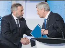  ?? THE CANADIAN PRESS ?? NDP Leader Tom Mulcair and Conservati­ve Leader Stephen Harper shake hands after the leaders debate Thursday in Toronto.