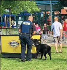  ??  ?? A Troy police dog makes the rounds in Riverfront Park prior to the beginning of Monday’s All-Star Fanfest.