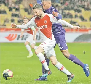  ?? — Gambar AFP ?? DIKAWAL KETAT: Fabregas (kiri) diasak hebat oleh pemain Toulouse pada perlawanan Ligue 1 Perancisv di Stade Louis II, Monaco pada Sabtu lepas.