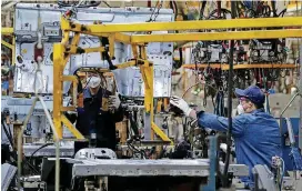  ?? [AP PHOTO] ?? Workers assemble the BAIC Jeep chassis frames at the Chinese automaker BAIC ORU assembly plant in Beijing on Aug. 29.