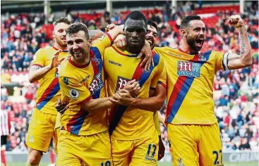  ?? — AP ?? Christian the saviour: Crystal Palace’s Christian Benteke (centre) celebrates with team-mates after scoring his side’s winning goal against Sunderland during their English Premier League match at The Stadium of Light yesterday. Palace came back from...