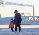  ??  ?? Amanda Timm and her son, Isaiah, make their way through icy Veterans Park in Milwaukee.MIKE DE SISTI/MILWAUKEE JOURNAL SENTINEL