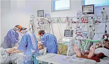  ?? — AFP photo ?? Health workers attend a Covid-19 patient at the Intensive Care Unit of the El Cruce Dr Nestor Kirchner hospital in Florencio Varela, Argentina.