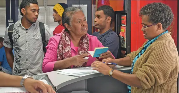  ?? Photo: Ronald Kumar ?? An Immigratio­n office staff helps a customer with her Passport in Suva on September 13, 2019.