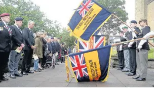  ??  ?? Royal British Legion standards are lowered in honour of those who died