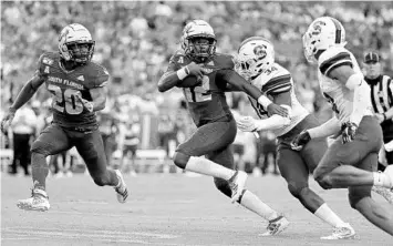  ?? MIKE EHRMANN/GETTY ?? USF’s Jordan McCloud, center, finished 16-of-27 passing for 217 yards and accounted for five touchdowns (three passing, two rushing) in slightly more than three quarters of the Bulls’ big victory Saturday against South Carolina State.