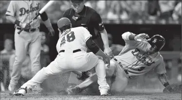  ?? JOHN SLEEZER/TRIBUNE NEWS SERVICE ?? Detroit Tigers' Nicholas Castellano­s scores on a wild pitch from Kansas City Royals relief pitcher Joakim Soria in the eighth inning on Monday in Kansas City, Mo.