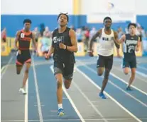  ?? BRIAN KRISTA/STAFF ?? Digital Harbor’s LaMont Johnson crosses the finish line, beating out the competitio­n in the 3A boys 300.