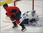  ?? NICK WASS — THE ASSOCIATED PRESS ?? Washington's Alex Ovechkin trips on the stick of Toronto goalie Erik Kallgren and is injured after crashing into the boards.