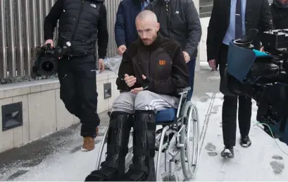  ??  ?? Murderer Keith Lee leaves the Criminal Courts of Justice in a wheelchair having jumped from a third-floor balcony. Photo: Gareth Chaney