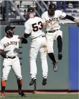  ??  ?? SAN FRANCISCO: San Francisco Giants’ Denard Span, left, Austin Slater (53) and Hunter Pence celebrates after the team’s 13-8 win over the Minnesota Twins in a baseball game Sunday, in San Francisco. — AP