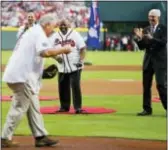  ?? JOHN BAZEMORE — THE ASSOCIATED PRESS ?? Former Atlanta Braves star Henry Aaron, rear, throws out the ceremonial first pitch to former manager Bobby Cox, left, as Chairman and CEO Terry McGuirk, right, looks on before the Braves’ first regularsea­son game in SunTrust Park.