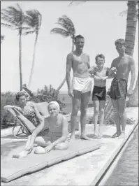  ?? The Associated Press ?? WE ARE FAMILY: John F. Kennedy, right, Robert F. Kennedy, second from right, and Patricia Kennedy, front left, pose with friends in Palm Beach, Fla. The Boston-based museum completed an 18-month project in 2018 to catalog and digitize more than 1,700 black-and-white Kennedy family snapshots that are viewable online, giving a nation still obsessed with "Camelot" a candid new glimpse into their everyday lives.