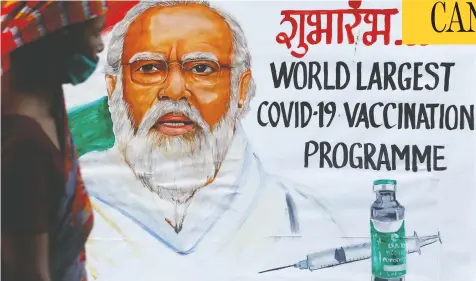  ?? FRANCIS MASCARENHA­S / REUTERS ?? A woman walks past a painting of Indian Prime Minister Narendra Modi promoting the nation's COVID-19 vaccinatio­n drive in Mumbai recently.