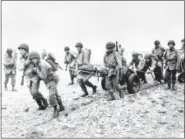  ?? THE ASSOCIATED PRESS ?? In this file photo, U.S. Army reinforcem­ents land on a beach during World War II on Attu Island, part of the Aleutian Islands of Alaska.