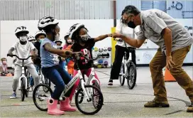  ?? COURTESY ?? Students at Barksdale Elementary try out the school’s recent gift of 24 new bikes. The donation also came with helmets and a curriculum to teach riding basics.