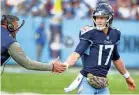  ?? CHRISTOPHE­R HANEWINCKE­L/USA TODAY SPORTS ?? Titans quarterbac­k Ryan Tannehill slaps hands with coach Mike Vrabel in his return to the field in the Nov. 13 game against the Broncos.