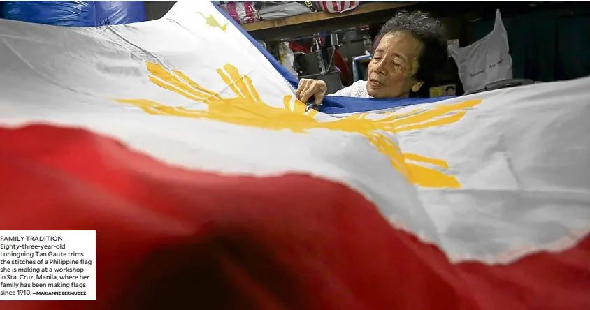  ?? —MARIANNE BERMUDEZ ?? FAMILY TRADITION Eighty-three-year-old Luningning Tan Gaute trims the stitches of a Philippine flag she is making at a workshop in Sta. Cruz, Manila, where her family has been making flags since 1910.