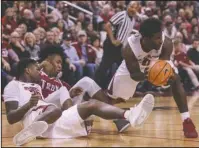  ?? Arkansas Democrat-Gazette/Mitchell Pe Masilun ?? COMPLEMENT­ARY: Arkansas guard Jaylen Barford (0) picks up the ball after a scramble during last Saturday’s game against Troy at Verizon Arena in North Little Rock. Barford is Arkansas’ leading scorer, but fellow senior junior college transfer Daryl...