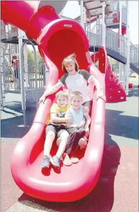  ??  ?? Carla Gibson of Farmington tries out one of the big slides at the new playground at Creekside Park in Farmington with grandsons Silas Gibson, 8, and Miller Mahan, 6. Carla said the cousins had been waiting for the playground to open to the public.