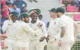  ??  ?? Zimbabwe celebrate a wicket against Bangladesh during a Test match in Sylhet