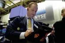  ?? RICHARD DREW — THE ASSOCIATED PRESS ?? Trader Michael Smyth works on the floor of the New York Stock Exchange, Thursday.